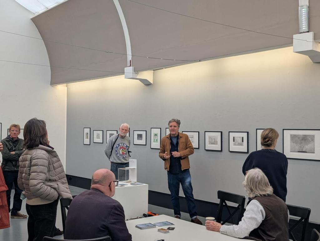 Nick talks to students in the Gallery surrounded by his drawings. 